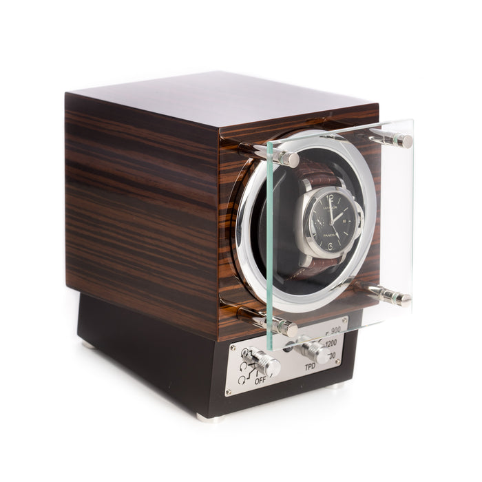 Occasion Gallery  "Ebony" Burlwood Watch Winder w/ Glass Door.  Winding Mode for Clockwise, Counterclockwise or Dual Direction Rotation. Winding Cycle for 900, 1200 or 1500 Rotations Per Day. AC Power. 5 L x 8 W x 7.5 H in.