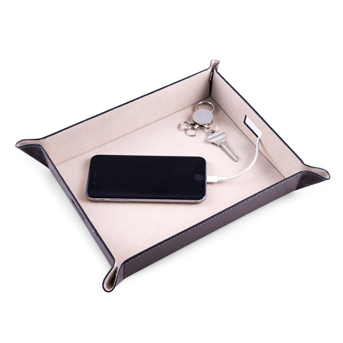 Occasion Gallery Brown Color Brown Leather Valet & Charging Station with Pig Skin Leather Lining. Continent Side Openings for Easy Charging Cord Pass-thru. 10 L x 7.75 W x 1.75 H in.