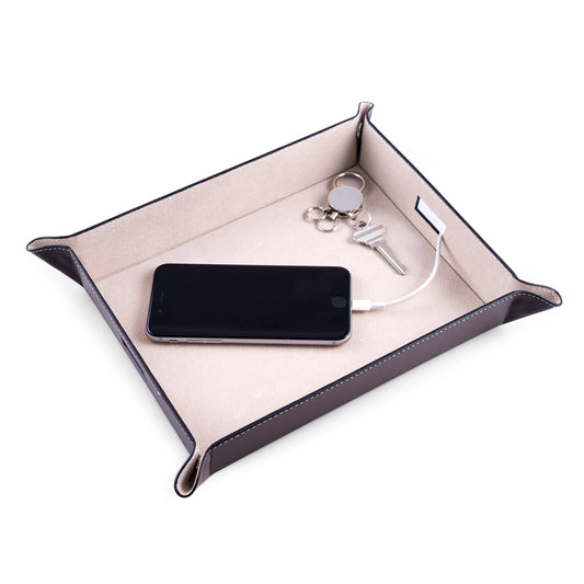 Occasion Gallery Brown Color Brown Leather Valet & Charging Station with Pig Skin Leather Lining. Continent Side Openings for Easy Charging Cord Pass-thru. 10 L x 7.75 W x 1.75 H in.