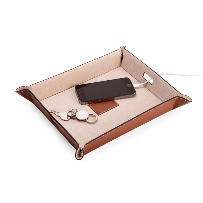 Occasion Gallery Saddle Color Saddle Brown Leather Valet & Charging Station with Pig Skin Leather Lining. Continent Side Openings for Easy Charging Cord Pass-thru. 10 L x 7.75 W x 1.75 H in.