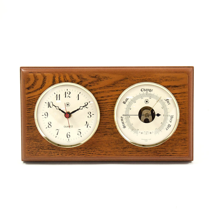 Occasion Gallery Oak Wood Color Quartz Clock and Barometer on Oak Wood with Brass Bezel. Wall Mounts Vertically or Horizontally. 6 L x 2 W x 11 H in.